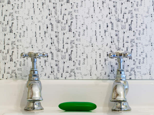 Monochrome retro glass splashback from Pineapple Sticks Collection, behind vintage sink. Black and white splashback.