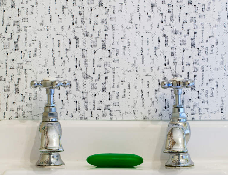 Monochrome retro glass splashback from Pineapple Sticks Collection, behind vintage sink. Black and white splashback.