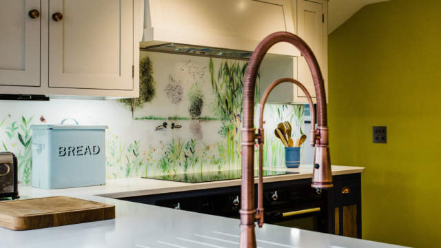 Bespoke glass splashback in country kitchen, with sink and hob