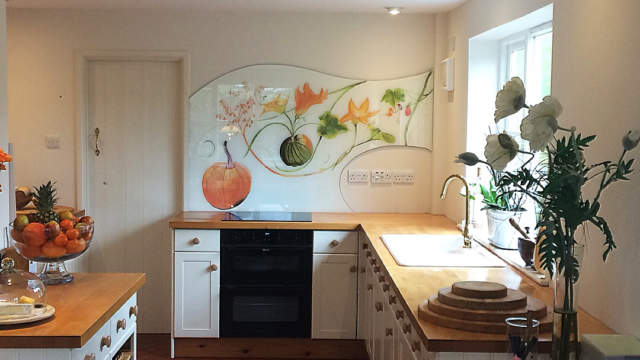 Bespoke shaped kitchen glass splashback with autumnal design