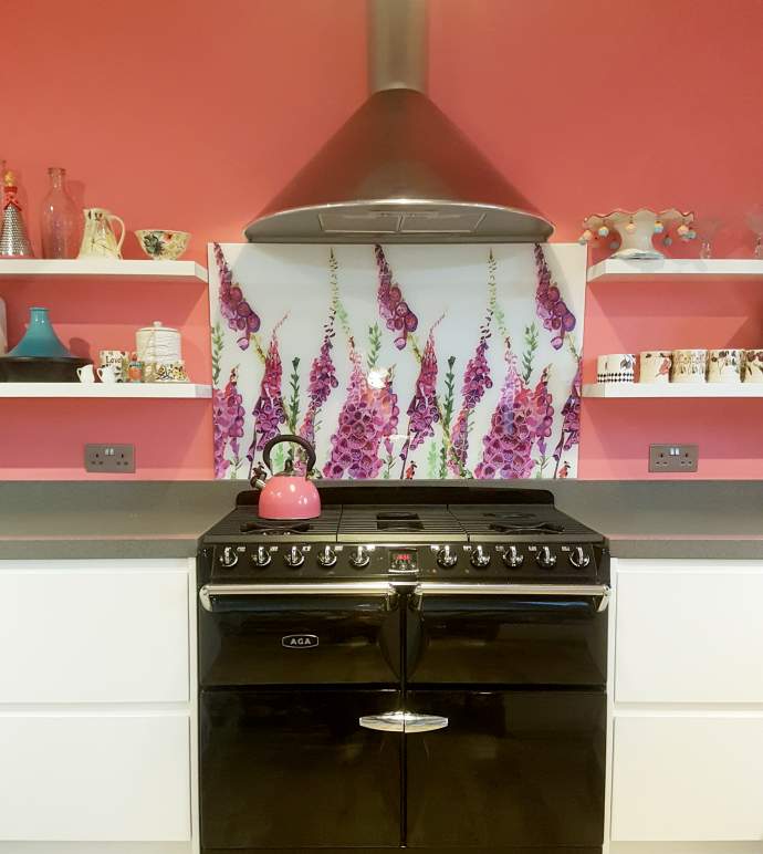 Foxglove splashback in a brightly coloured kitchen with a black Aga