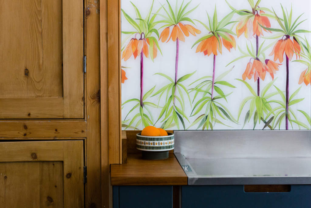 'Sunset' Hand painted glass splashback featuring orange frittillaria