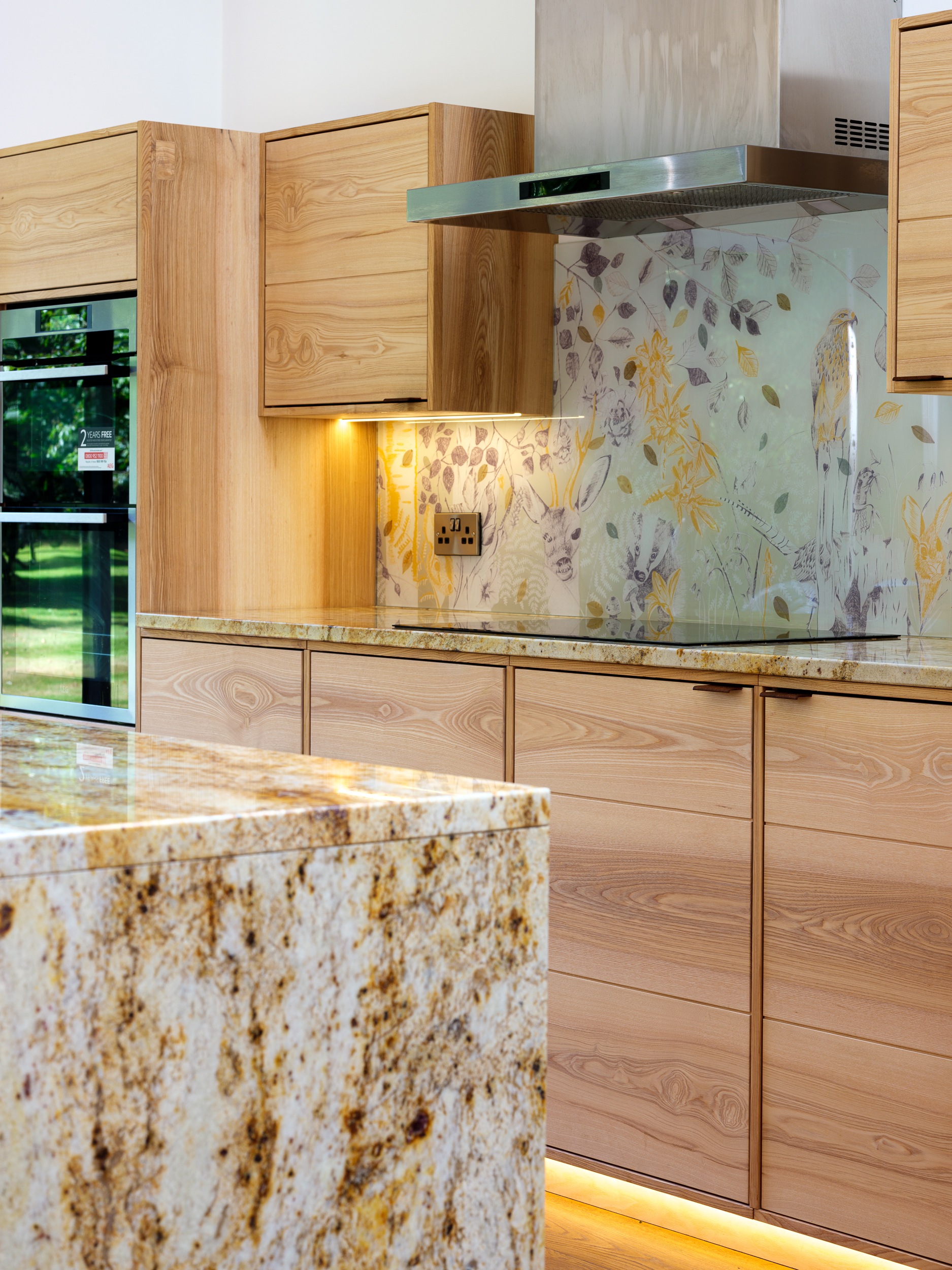 Finished artisan wooden kitchen featuring Emma Britton Glass Project on the wall.