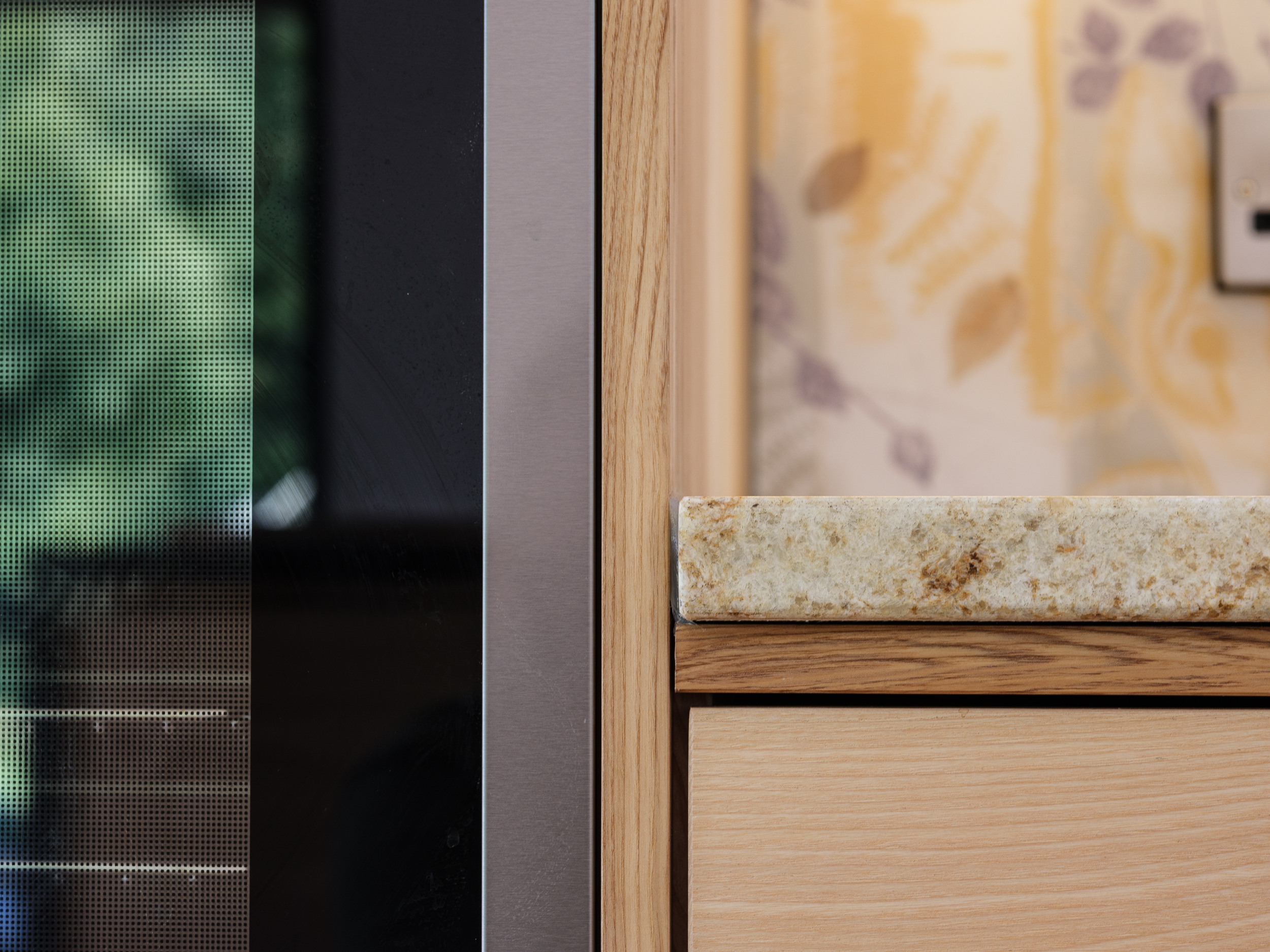 Details of kitchen finishes in room for a woodland look wall protector made in Emma Britton glass design.