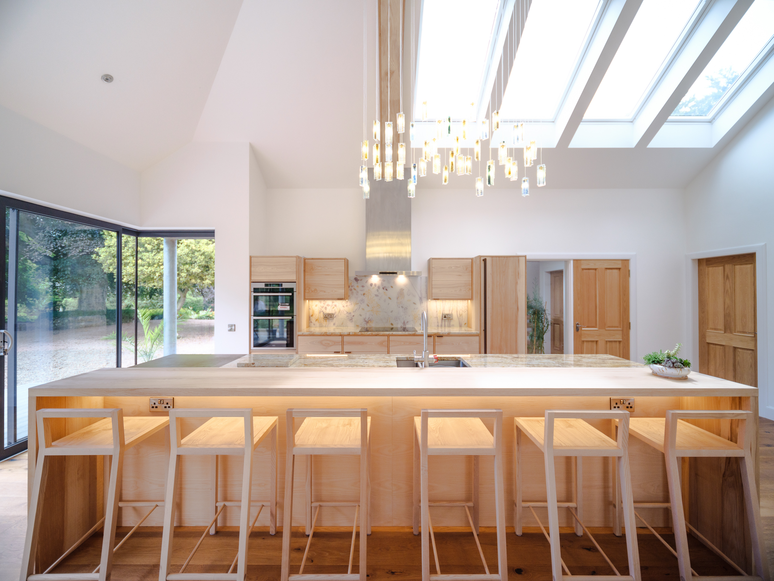 Emma Britton - overall kitchen image with her work on the wall. Care an attention to create a bespoke splashback is really worthwhile.
