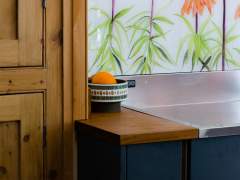 Emma-Britton-Sunset-Orange-Floral-Splashback-for-Wooden-Kitchen