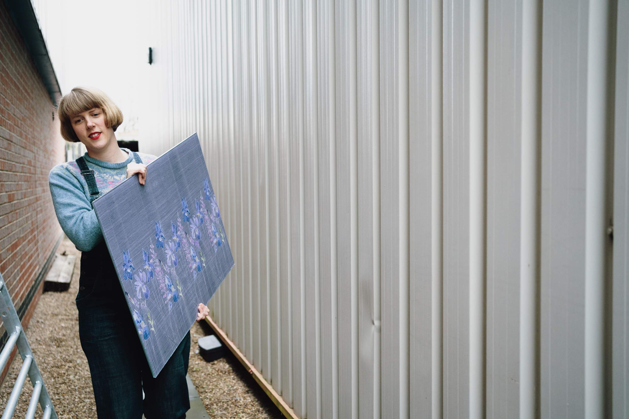 Emma Britton carrying Watercolour in Grey Glass Splashback, her original design at her studio.