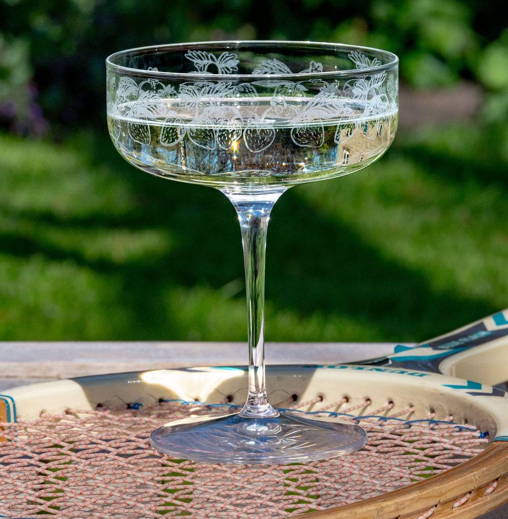 Emma Britton Strawberry Design Crystal Coupe Glass filled with Champagne