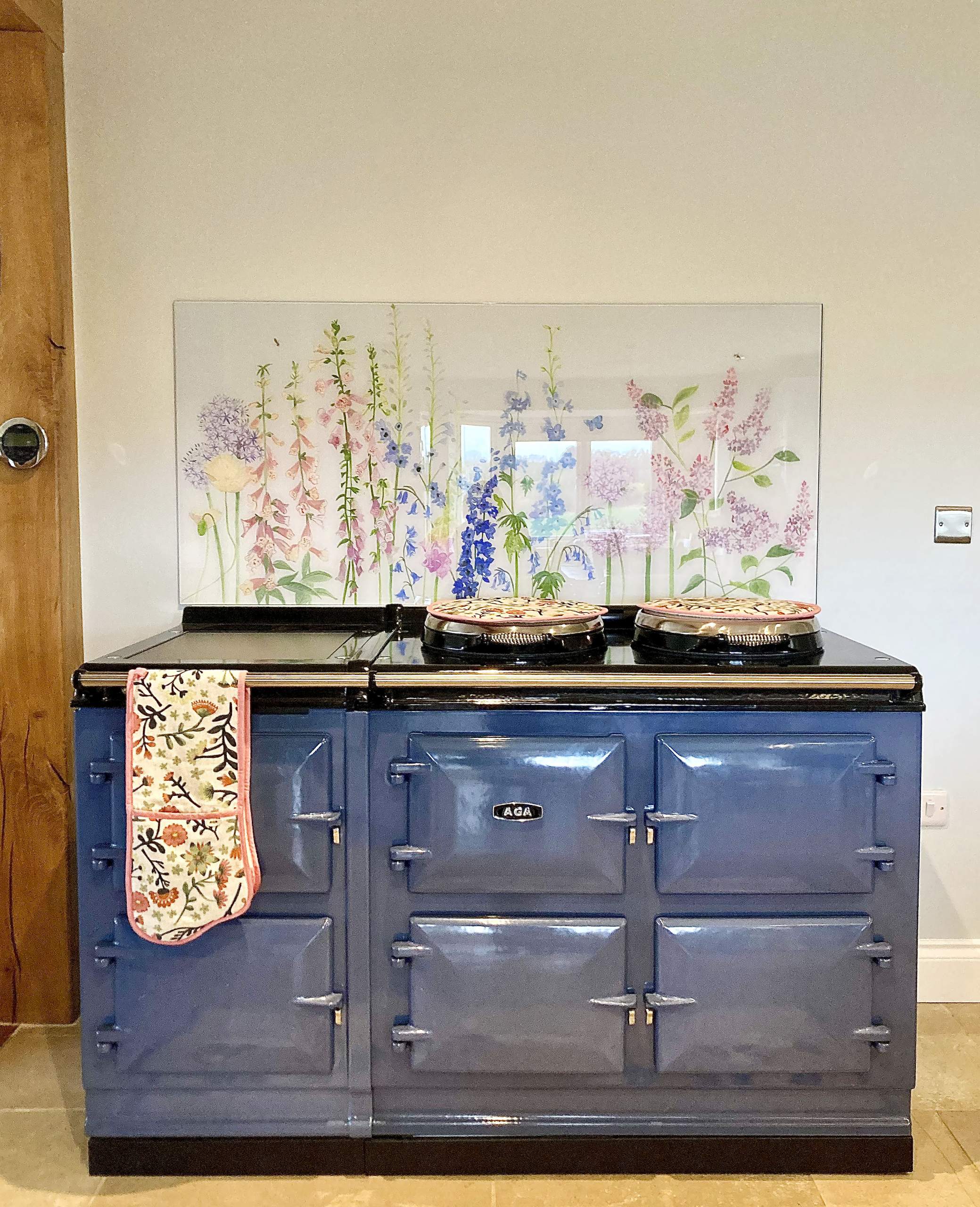 Emma Britton Bespoke floral splashback behind AGA Dartmouth Blue